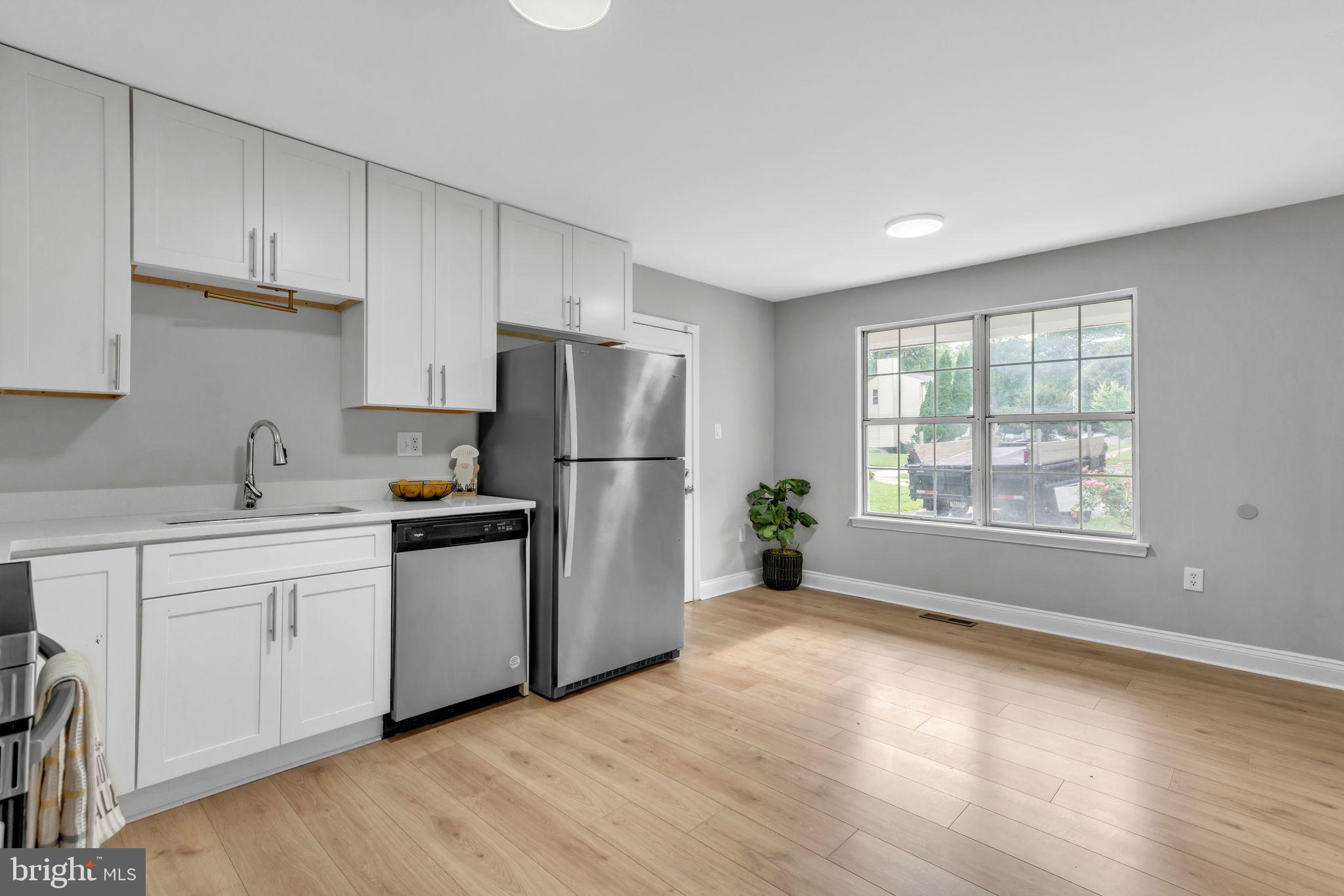 7400 Jaffrey Road Fort Washington, MD 20744 - Photo 13 of 31 a kitchen with a refrigerator and a sink