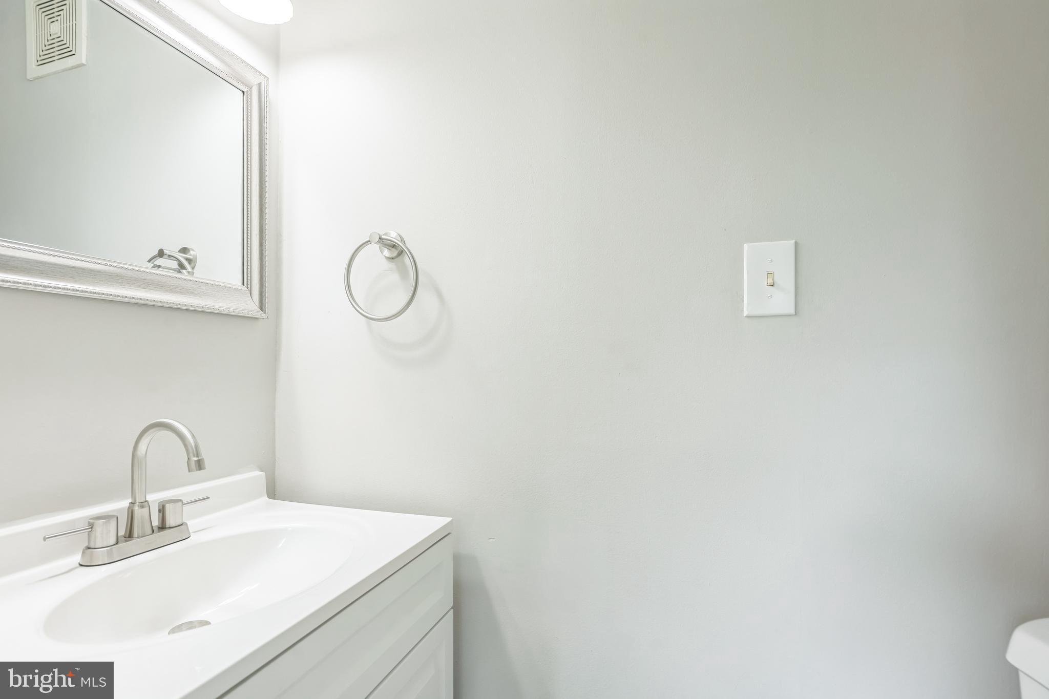 7400 Jaffrey Road Fort Washington, MD 20744 - Photo 19 of 31 a bathroom with a sink and a mirror