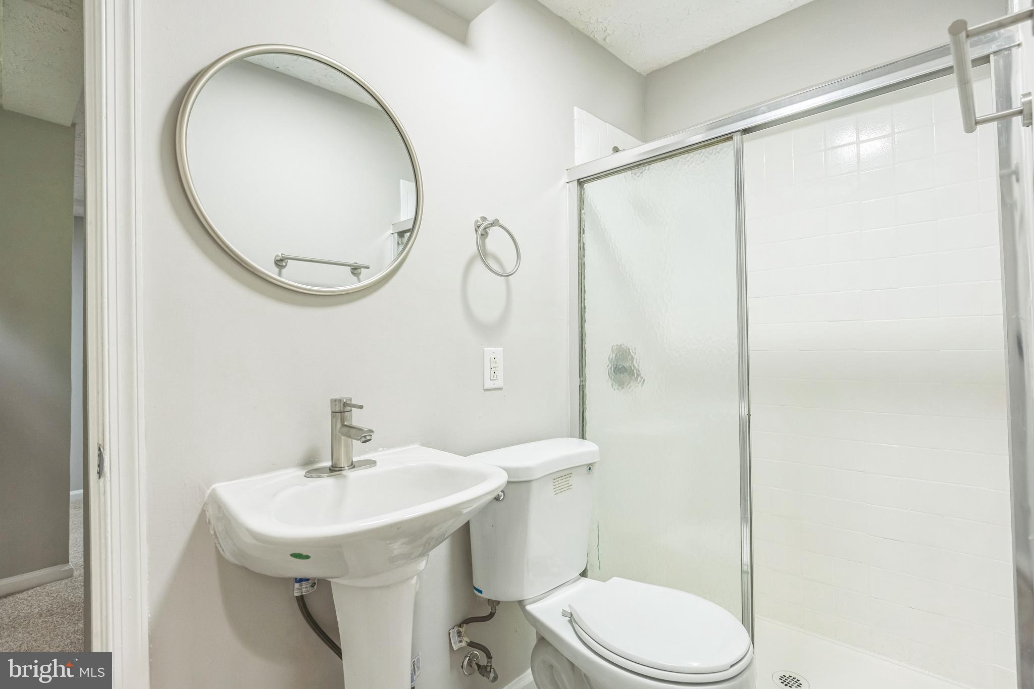 7400 Jaffrey Road Fort Washington, MD 20744 - Photo 20 of 31 a bathroom with a sink a toilet and a mirror