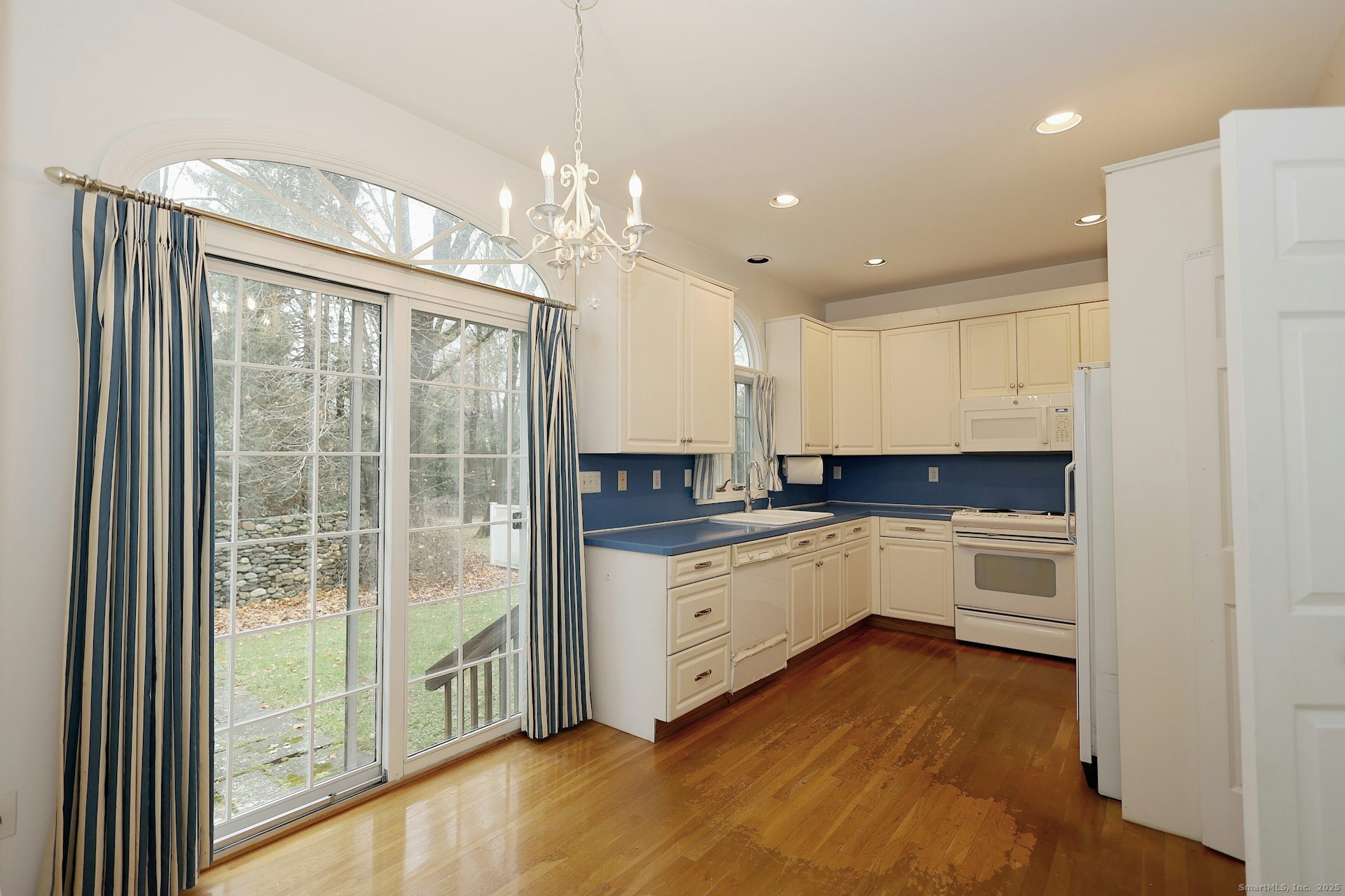 1213 Cedar Road Fairfield, CT 06890 - Photo 13 of 40 a kitchen with granite countertop a stove top oven a sink and white cabinets