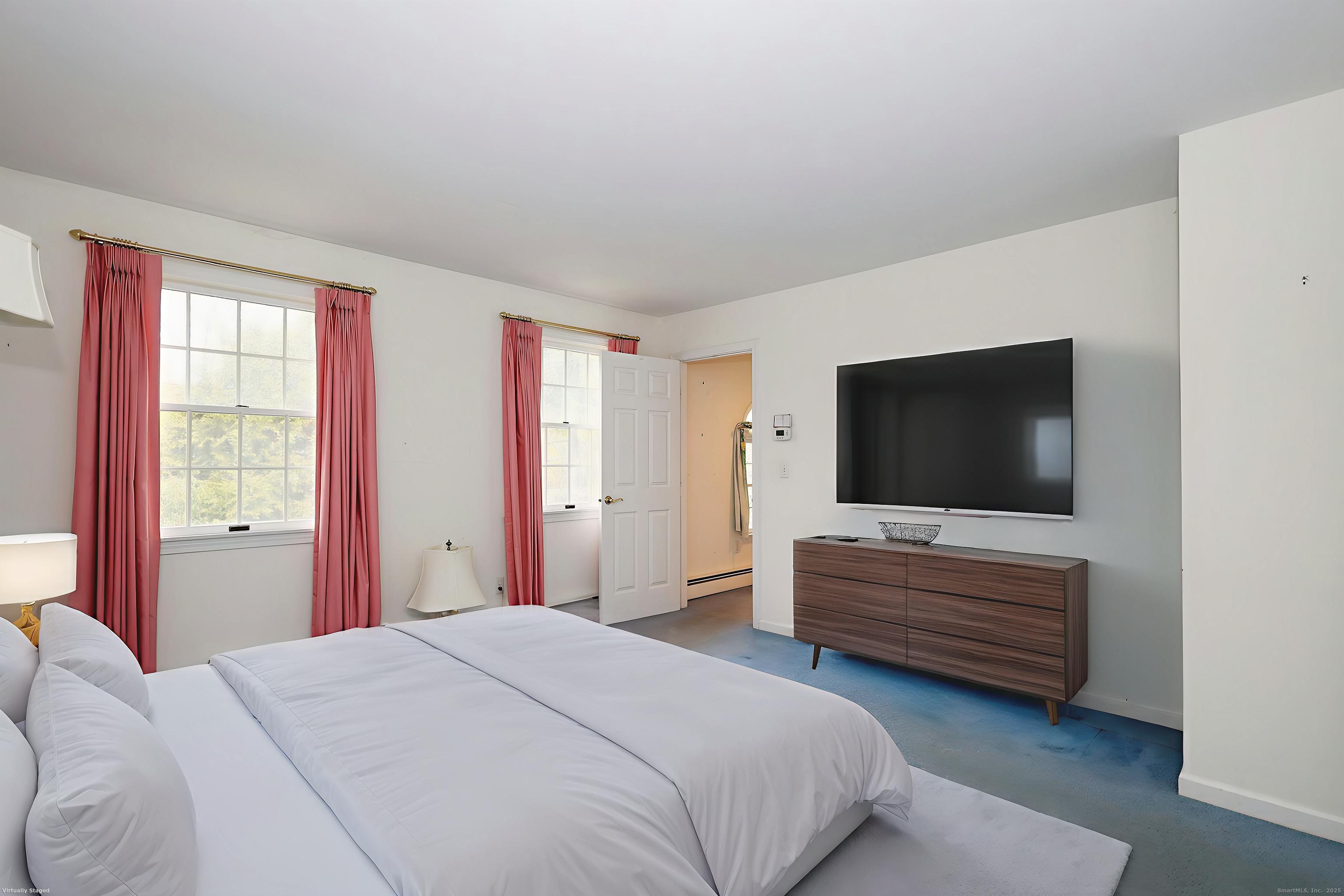 1213 Cedar Road Fairfield, CT 06890 - Photo 22 of 40 a bedroom with a bed and a flat screen tv