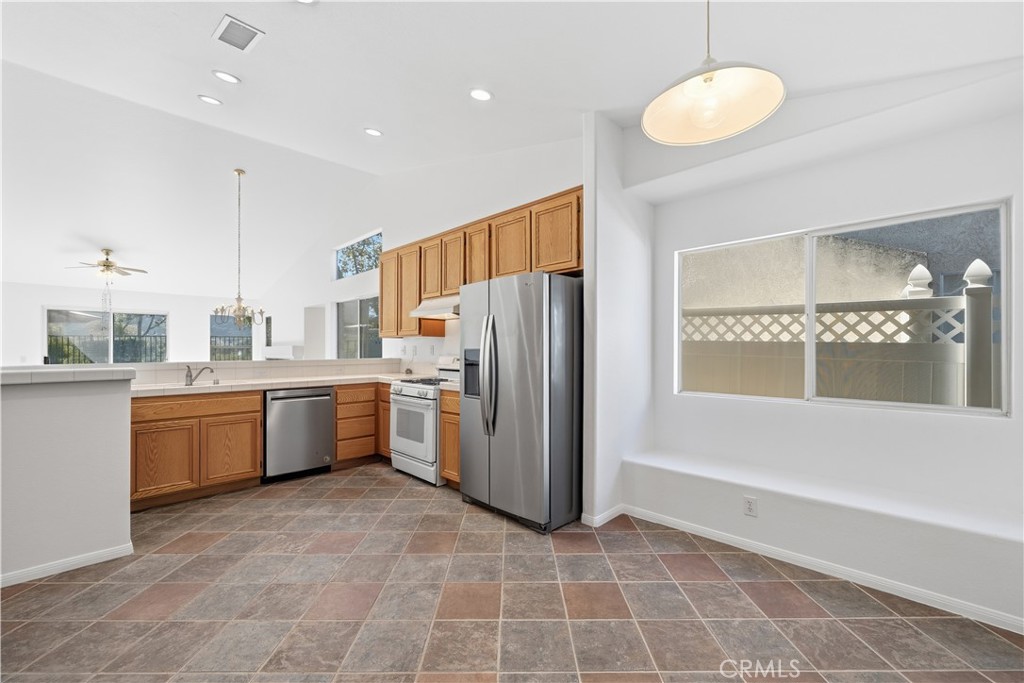 4875 Lake Shore Place Fallbrook, CA 92028 - Photo 11 of 31 a kitchen with a refrigerator a sink and dishwasher