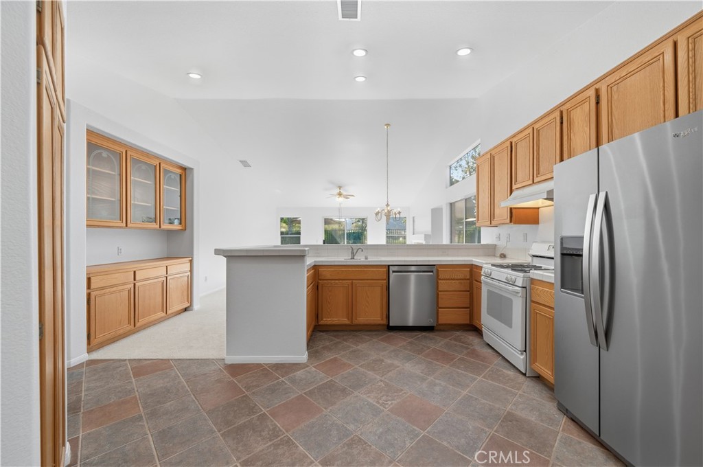 4875 Lake Shore Place Fallbrook, CA 92028 - Photo 12 of 31 a kitchen with stainless steel appliances a refrigerator sink and cabinets