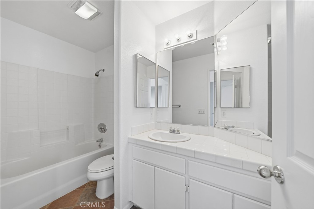 4875 Lake Shore Place Fallbrook, CA 92028 - Photo 19 of 31 a bathroom with a sink a toilet and a large mirror