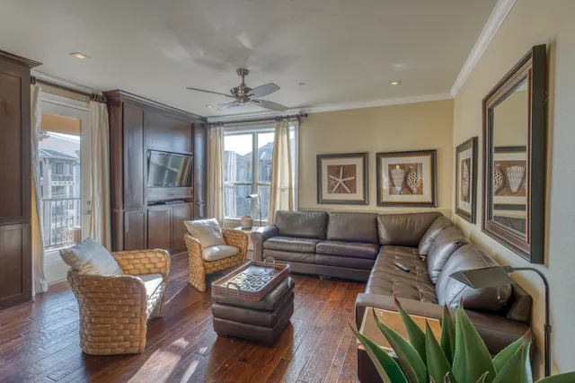 a living room with furniture ceiling fan and a window