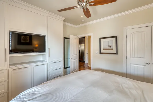 a bedroom with a bed and a flat screen tv