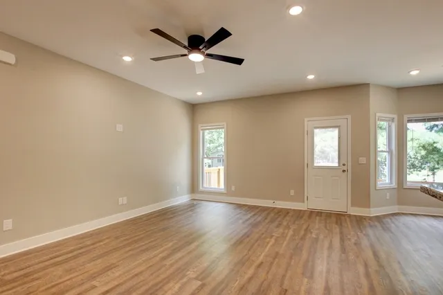 a view of a kitchen with a sink and wooden floor