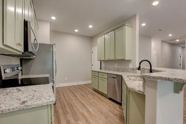 an empty room with wooden floor and a ceiling fan
