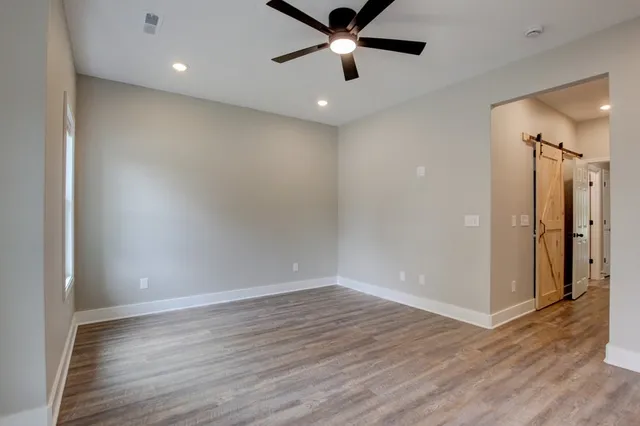a view of a hallway with wooden floor