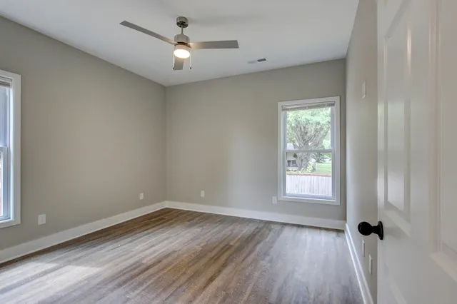 a view of a kitchen with a sink wooden floor and windows