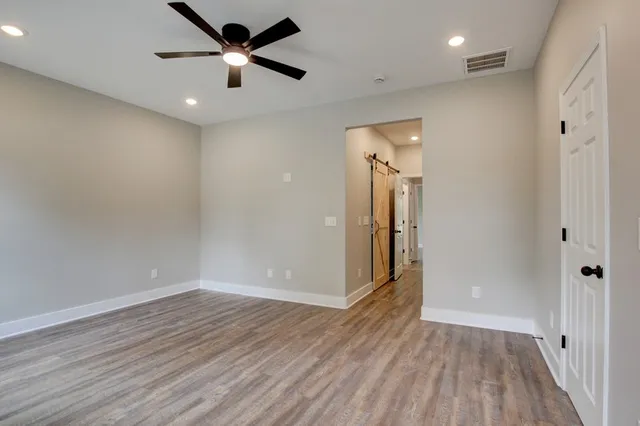 a view of a house with a yard and wooden fence