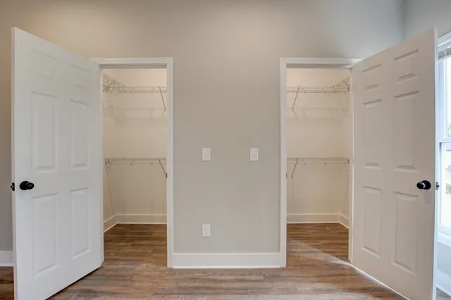 a kitchen with stainless steel appliances granite countertop white cabinets a stove a microwave and a refrigerator