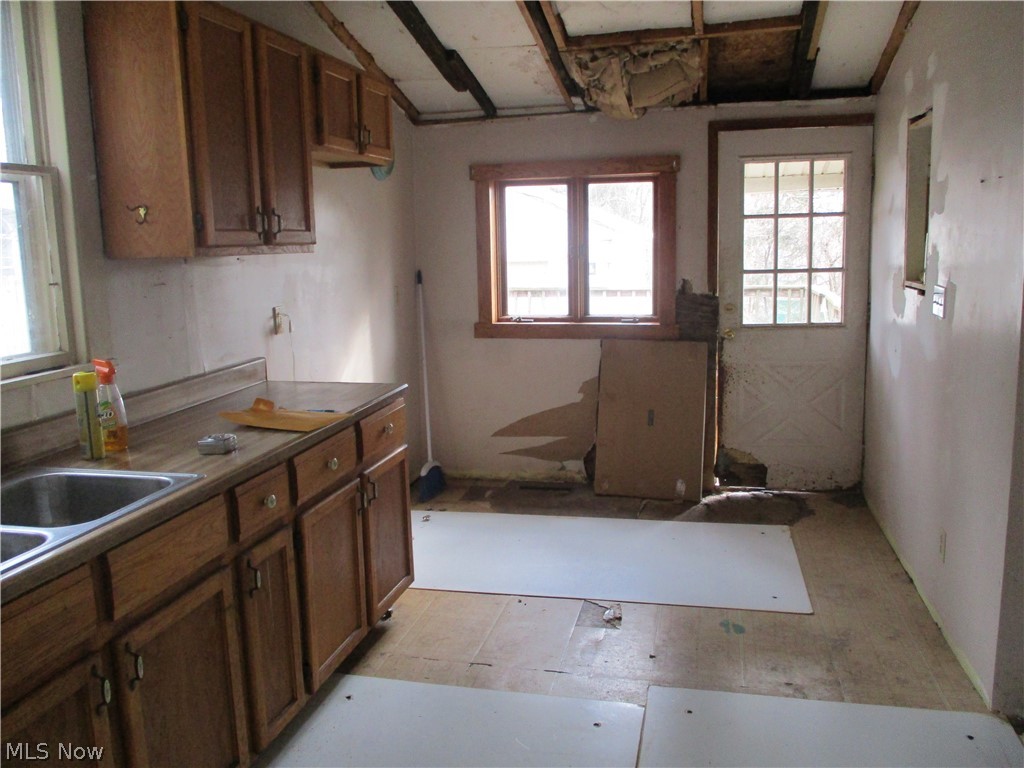 14831 Calaboone Road Doylestown, OH 44230 - Photo 7 of 14 Kitchen with wood finish cabinets and lofted ceiling
