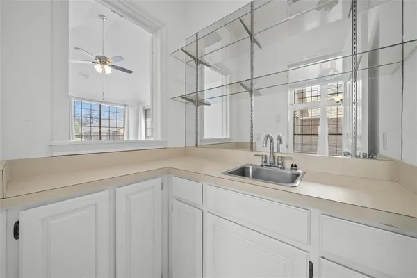 a bathroom with a sink and a window