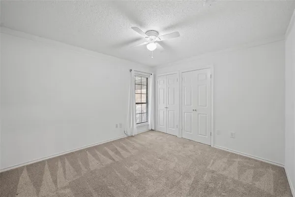 a view of an empty room with a ceiling fan