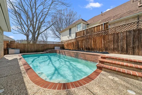 a view of a swimming pool with a lounge chair