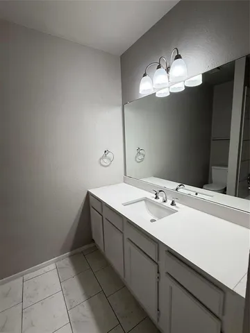 a bathroom with a sink vanity and a mirror