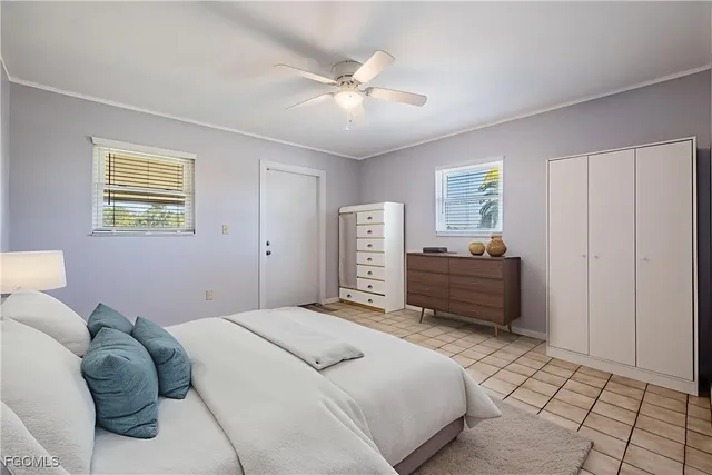 a bedroom with a bed dresser and a window