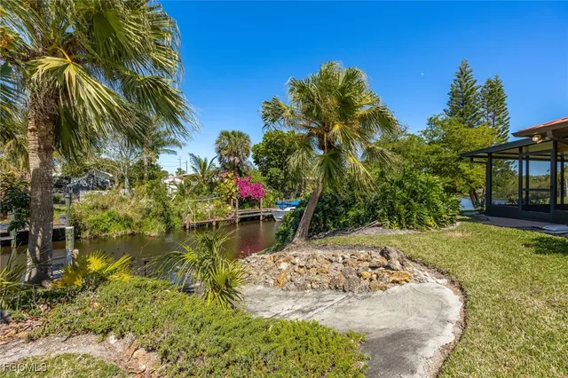 a view of a lake with palm trees