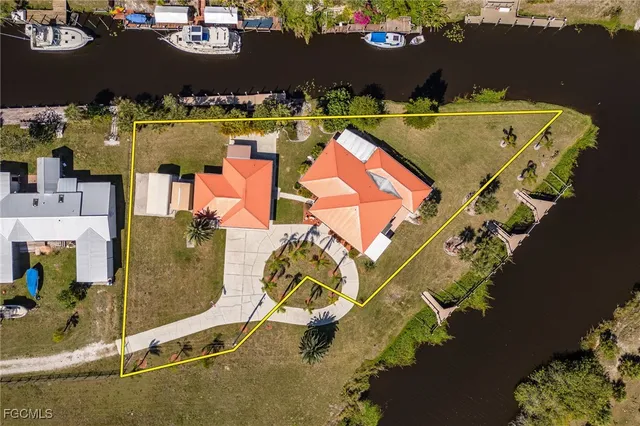 an aerial view of house with yard swimming pool and ocean view