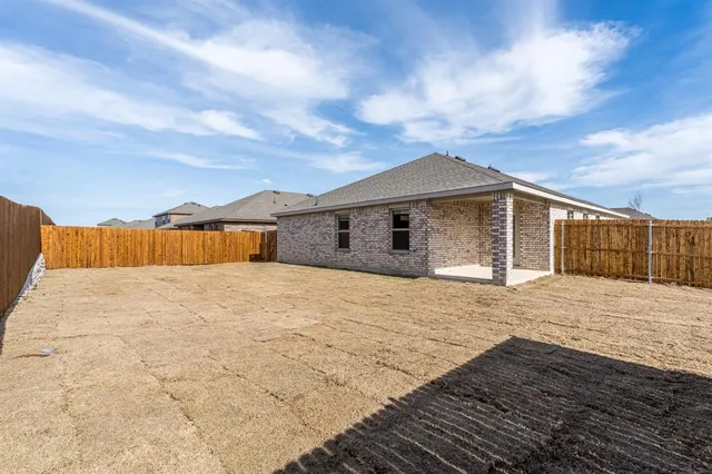 a view of a house with wooden fence