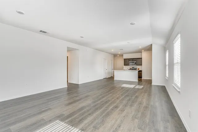 a view of a kitchen with a sink and wooden floor