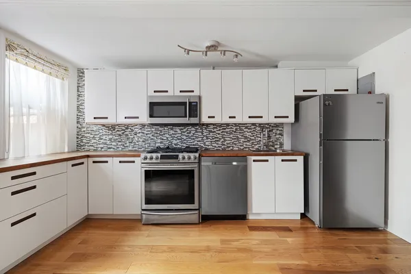 a view of a room with wooden floor