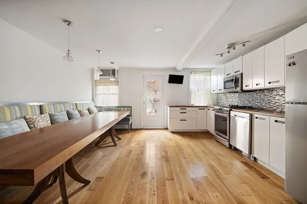 a kitchen with granite countertop a refrigerator stove and microwave