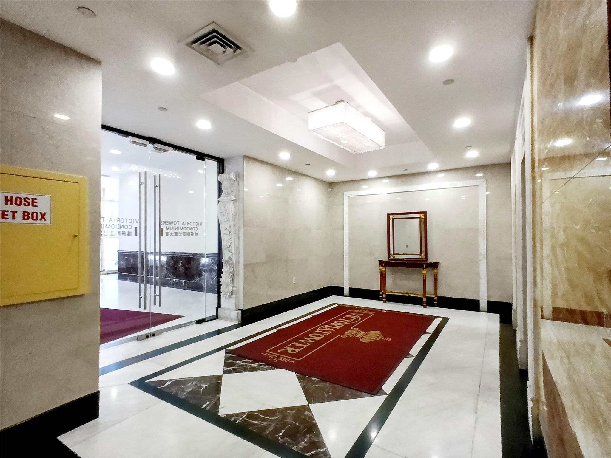 133-38 Sanford Avenue, Unit 6A Queens, NY 11355 - Photo 17 of 22 a lobby with a rug and a glass door space