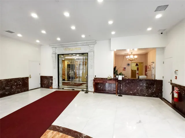 a living room with furniture a couch and large window