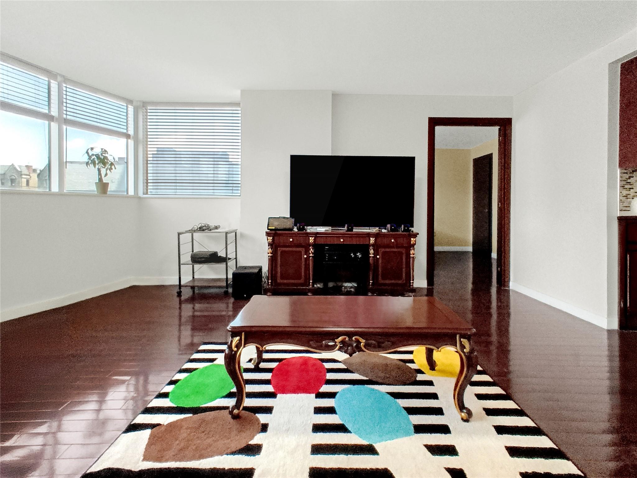 133-38 Sanford Avenue, Unit 6A Queens, NY 11355 - Photo 7 of 22 a room with furniture and a flat screen tv