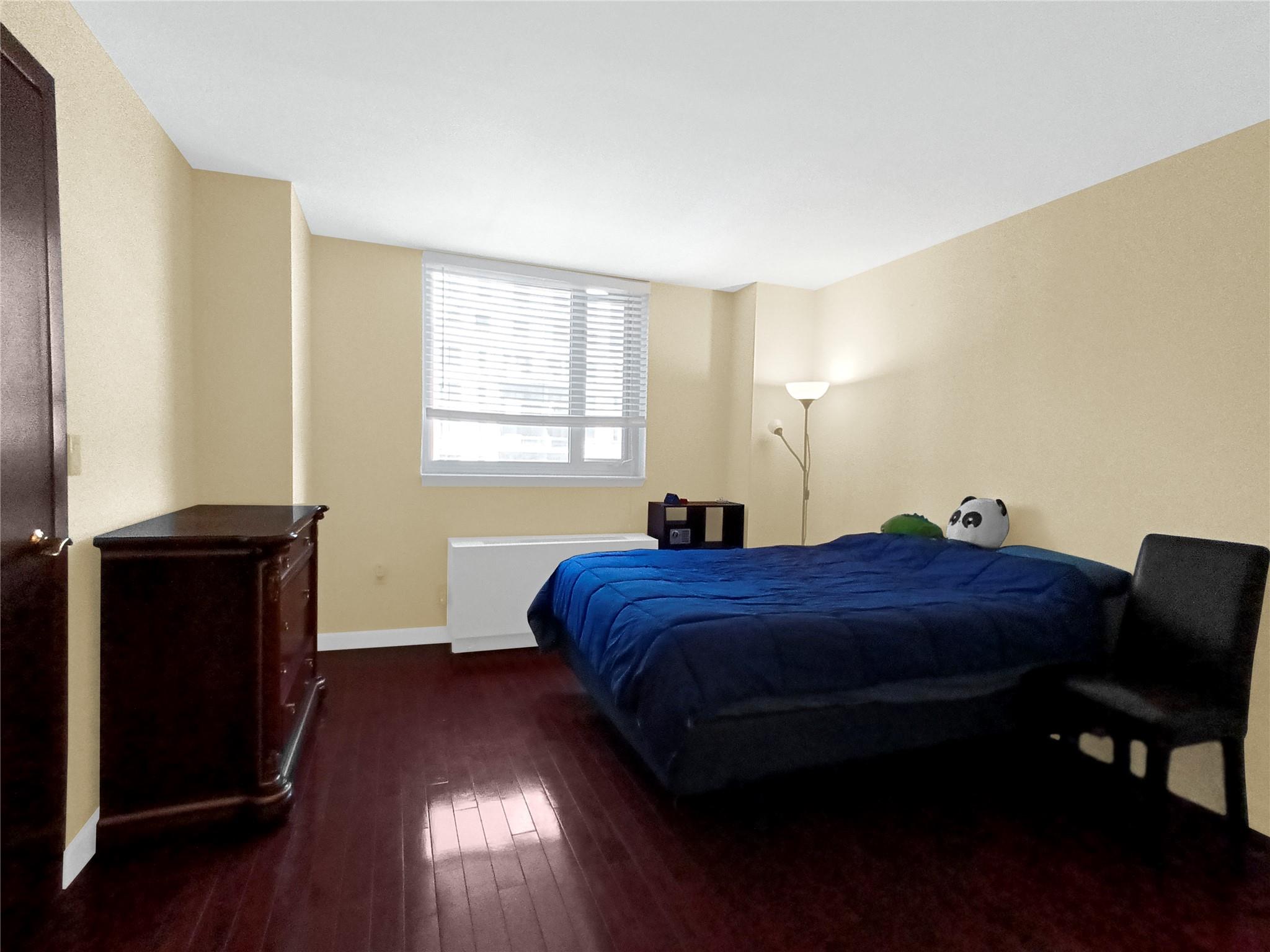 133-38 Sanford Avenue, Unit 6A Queens, NY 11355 - Photo 8 of 22 a bedroom with a bed and a window