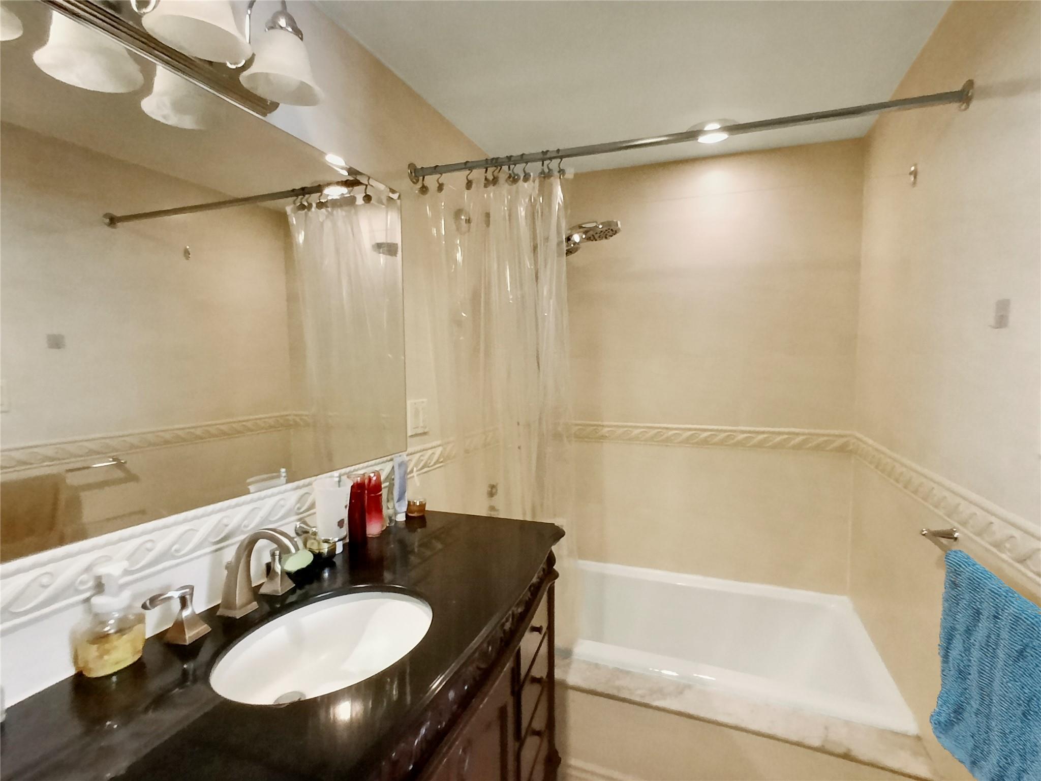 133-38 Sanford Avenue, Unit 6A Queens, NY 11355 - Photo 10 of 22 a bathroom with a sink and a mirror