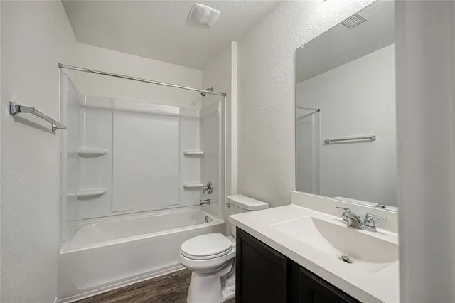 a bathroom with a sink toilet tub and shower