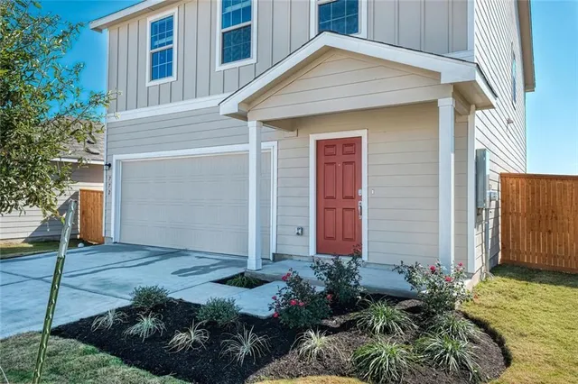 a view of a house with potted plants