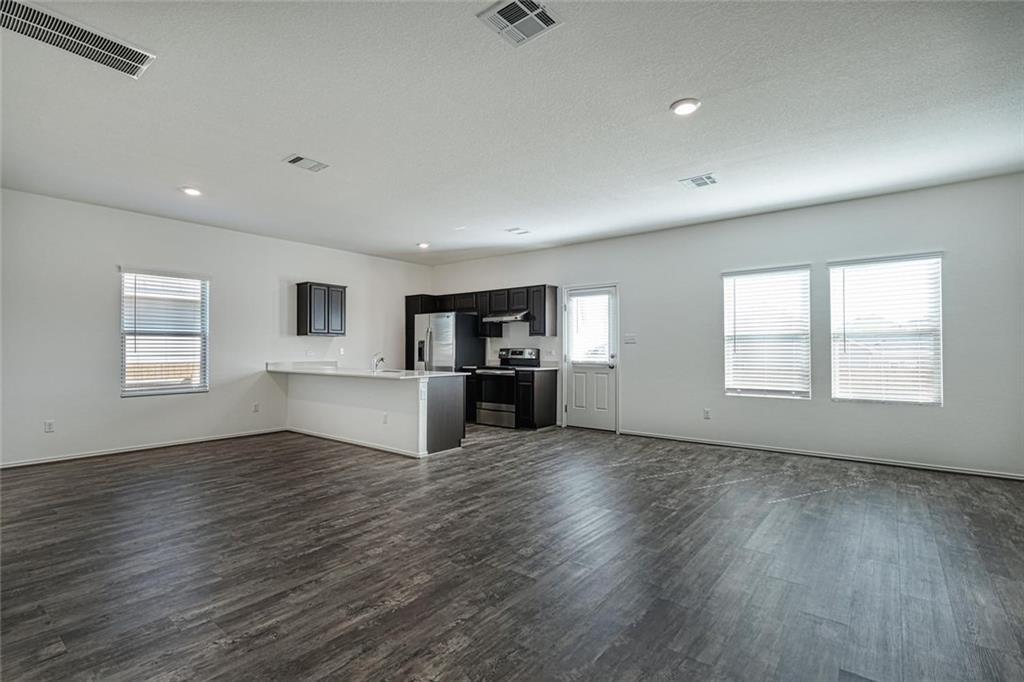 772 Circle Way Jarrell, TX 76537 - Photo 3 of 20 a view of empty room with wooden floor and windows