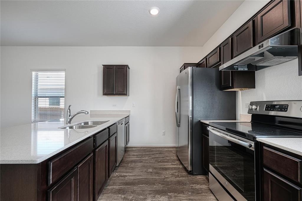 772 Circle Way Jarrell, TX 76537 - Photo 5 of 20 a kitchen with stainless steel appliances granite countertop a sink stove and refrigerator