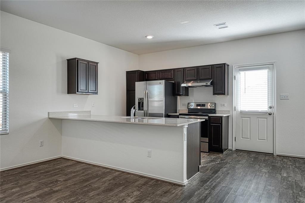772 Circle Way Jarrell, TX 76537 - Photo 7 of 20 a kitchen with stainless steel appliances granite countertop a sink stove and refrigerator