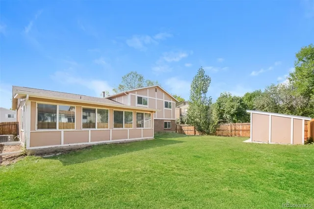 a view of a house with a yard and sitting area