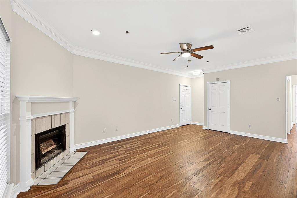 5407 Bryan Street, Unit B104 Dallas, TX 75206 - Photo 31 of 38 an empty room with fan and a fireplace