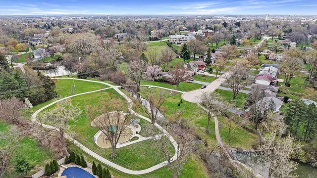 an aerial view of a house with a yard swimming pool outdoor seating
