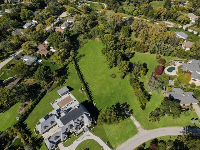 an aerial view of a residential houses with outdoor space