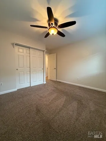 a view of empty room with ceiling fan