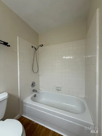 a bathroom with a bathtub and a toilet