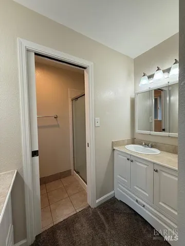 a bathroom with a double vanity sink and mirror
