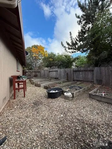 a backyard of a house with table and chairs