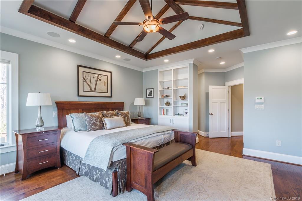 2649 River Ridge Place Fort Mill, SC 29708 - Photo 14 of 34 a spacious bedroom with a bed and a chandelier