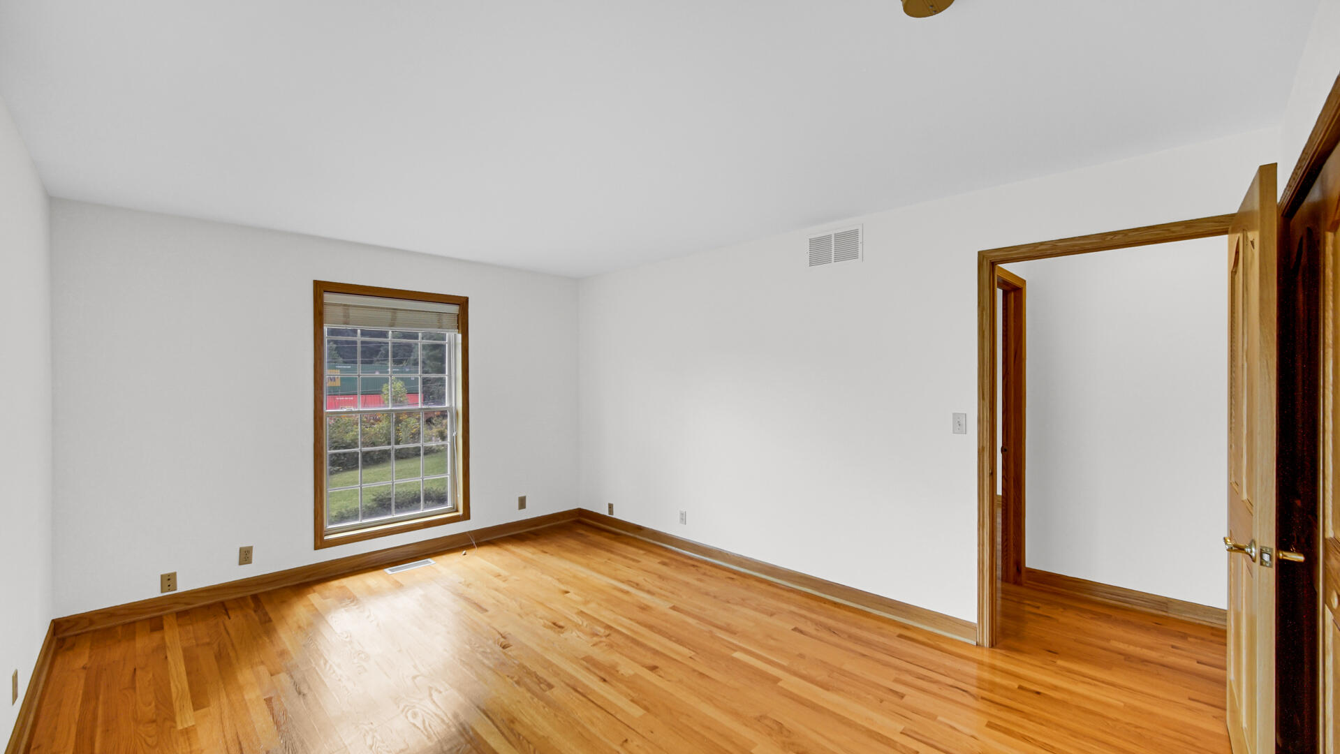 11339 West Snyder Road Westville, IN 46391 - Photo 15 of 27 an empty room with wooden floor and windows