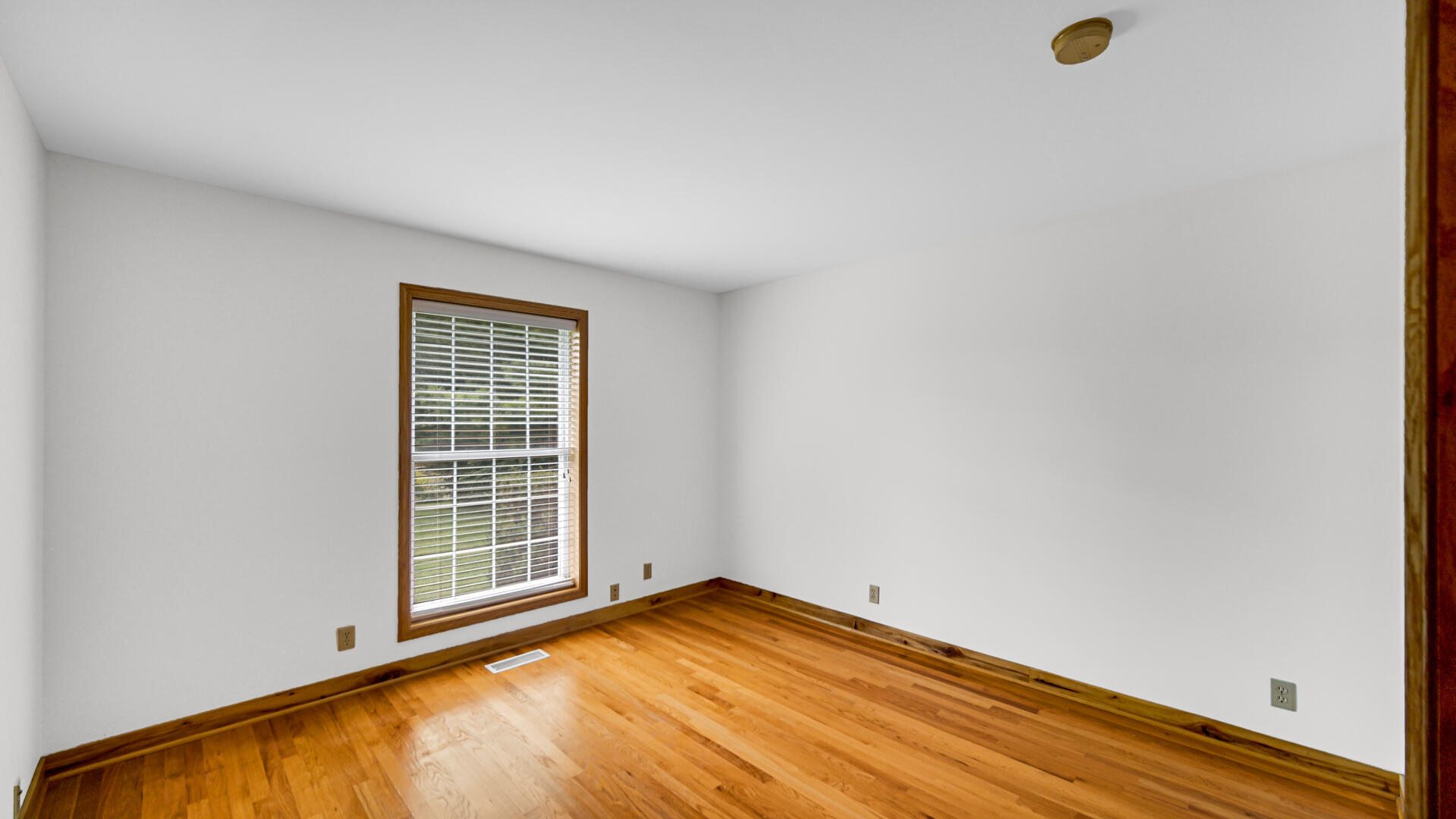 11339 West Snyder Road Westville, IN 46391 - Photo 16 of 27 a view of empty room with wooden floor and fan