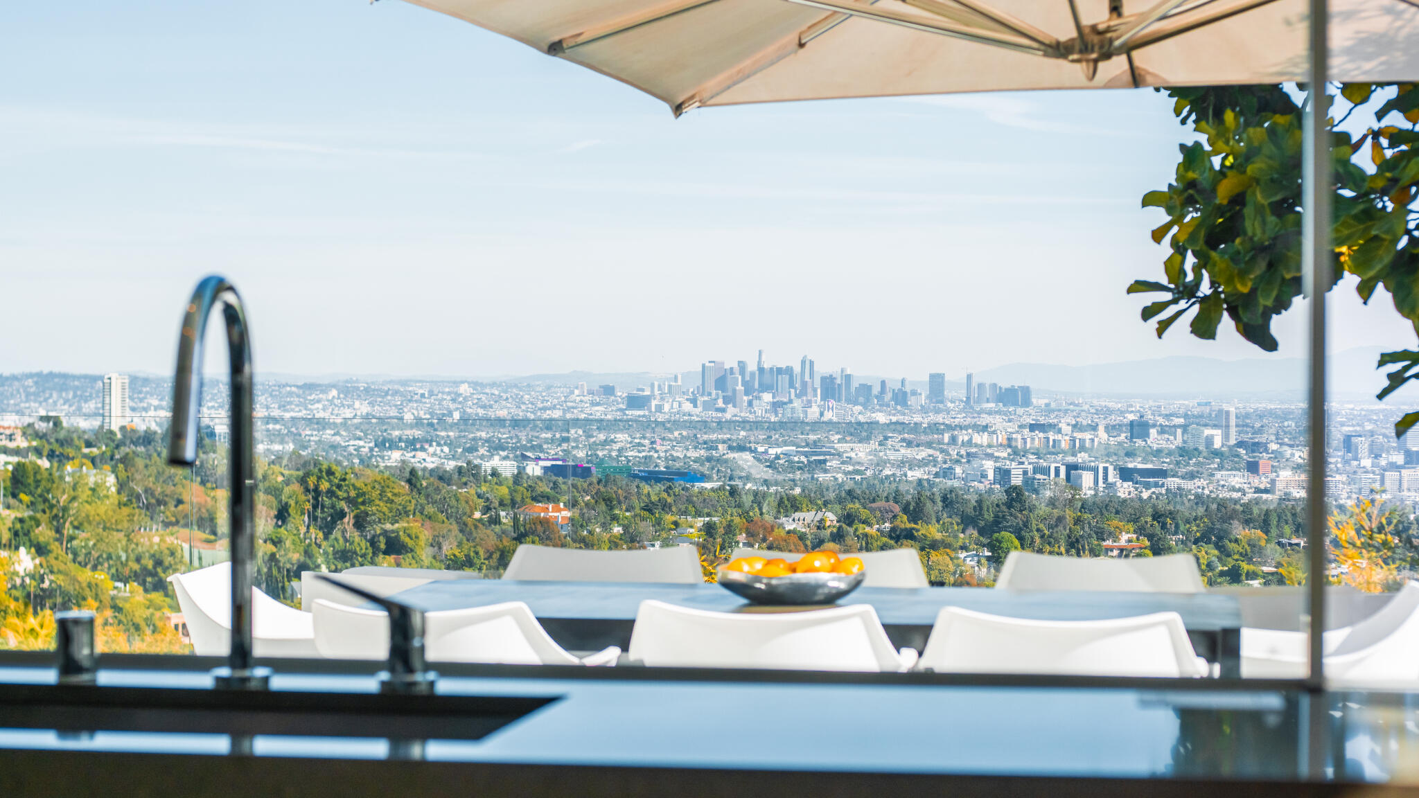 1288 Angelo Drive Beverly Hills, CA 90210 - Photo 12 of 33 a view of a terrace with couches and a table